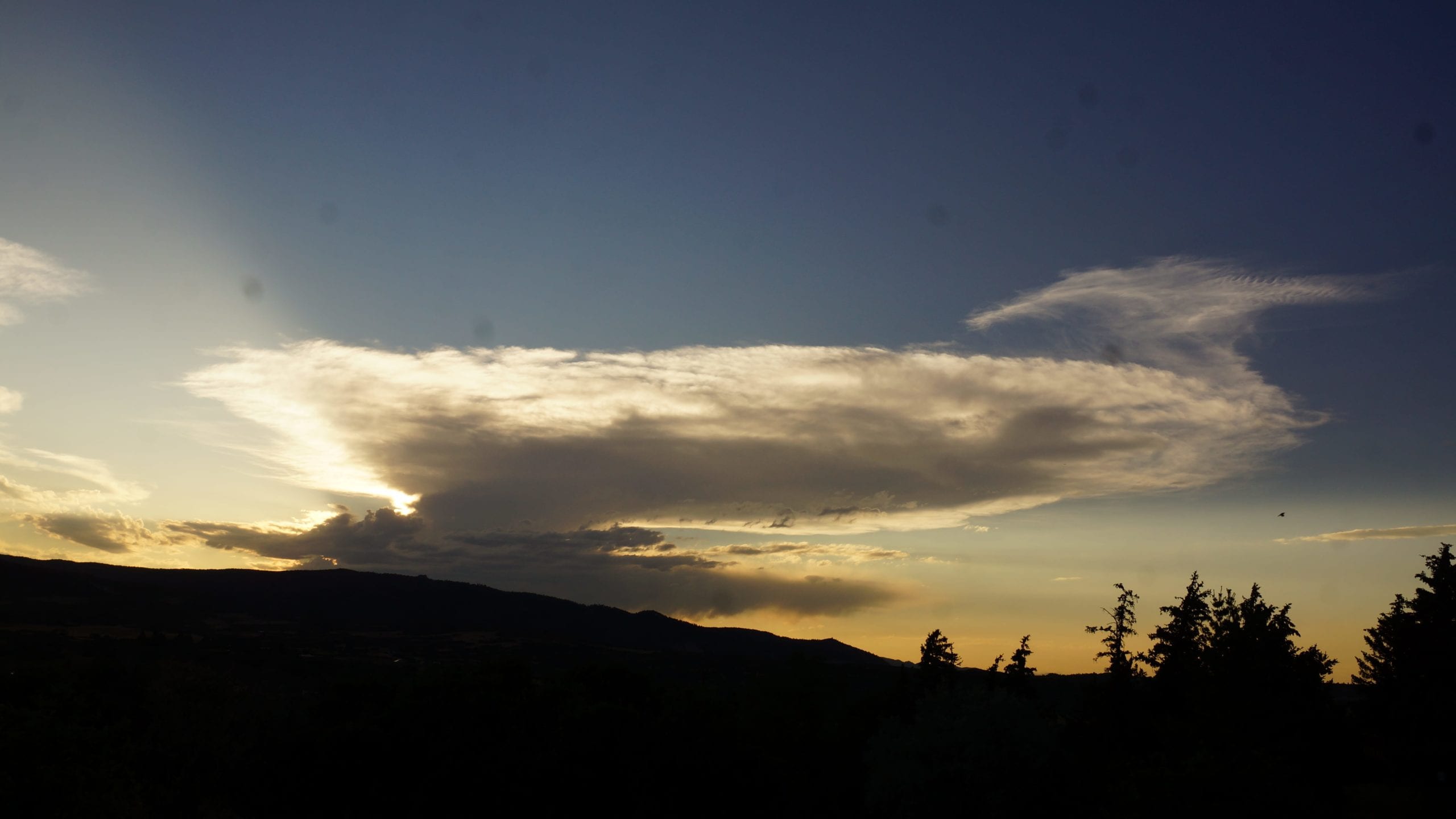 July sunset in Colorado with a dissolving thunderhead